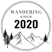 the wandering since logo with trees in the background