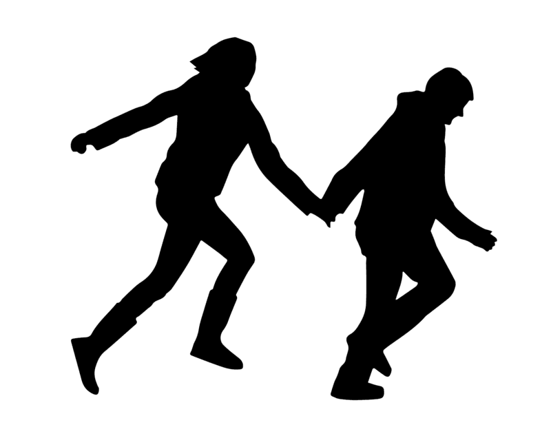 two people holding hands while walking
