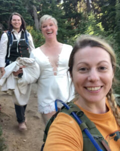 three women are taking a selfie in the woods