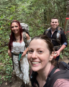 three people are hiking in the woods together
