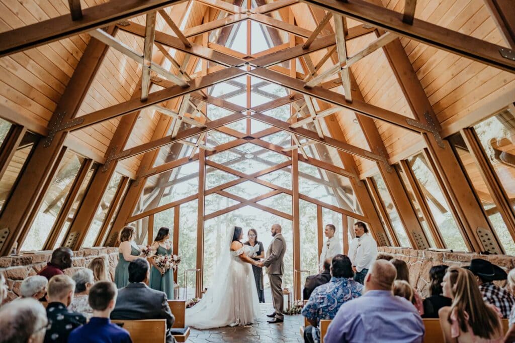 a couple getting married in a large wooden building