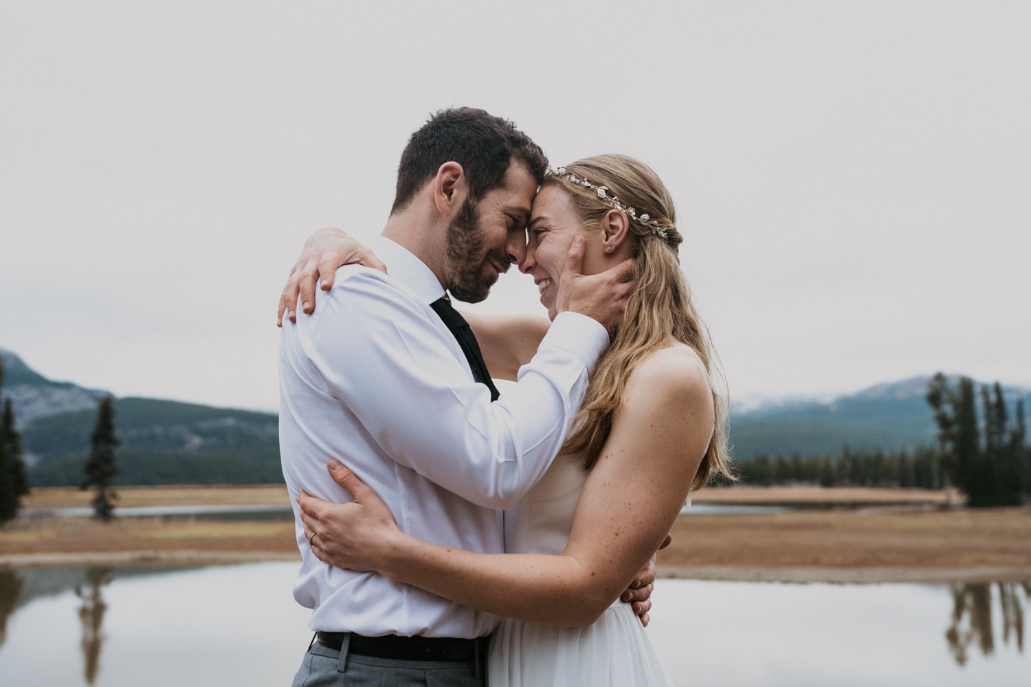a man and woman embracing each other in front of Sparks lake