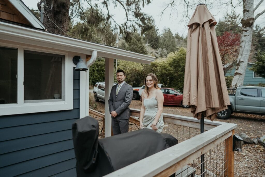 a man and woman standing on a porch