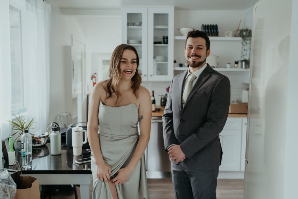 a man and woman standing next to each other in a kitchen