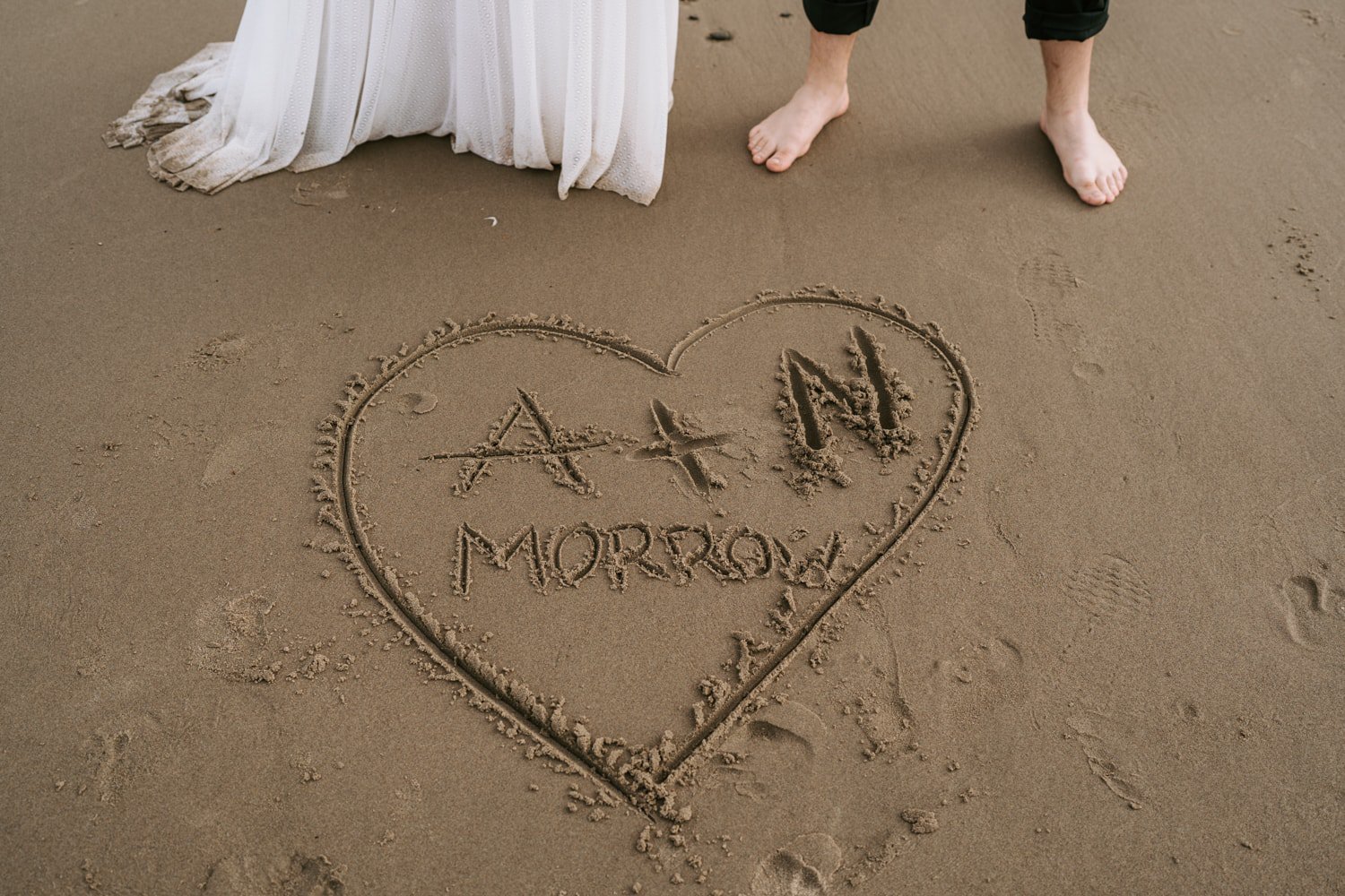 A heart drawn in the sand after Ashley and Noah's Hug Point wedding.