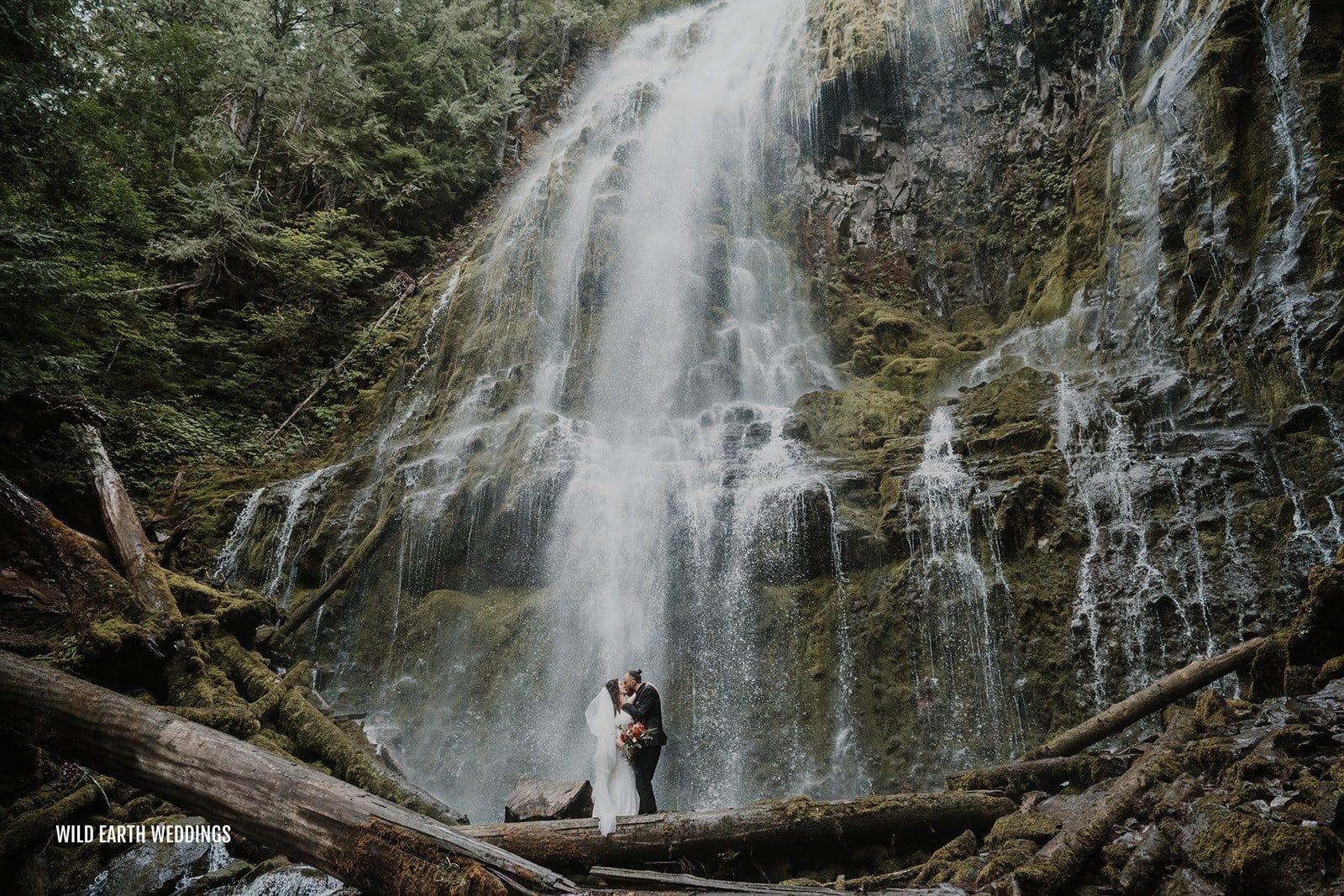 A couple is married next to a waterfall in Oregon.