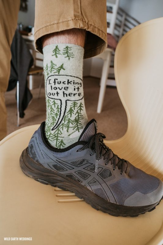 a person wearing socks with trees on them